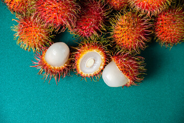 fresh ripe red rambutans (Nephelium lappaceum) on Green Background 5