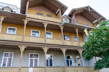 Wooden balcony of a wood house. Exterior facade windows. Old architecture home