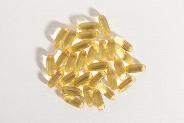 Transparent vitamin capsules on white background. Fish oil, omega 3