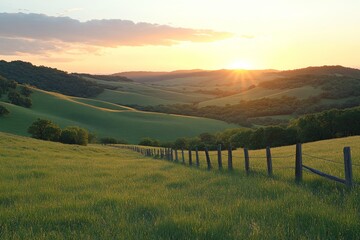 Obraz premium Fence-lined grassy hill at sunrise with soft light