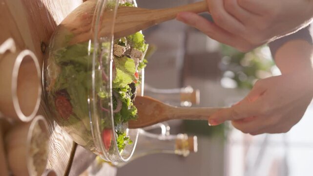 Vertical Shot of Balanced Eating in Action: A Colorful Mediterranean Salad Prepared with Fresh Ingredients in a Cheerful Kitchen Setting
