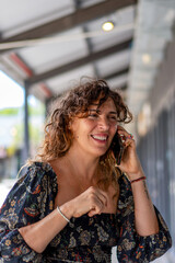 Joyful woman talking on the phone while enjoying a day out