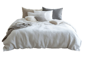 Cozy white linen duvet on a neatly arranged bed with fluffy cushions.