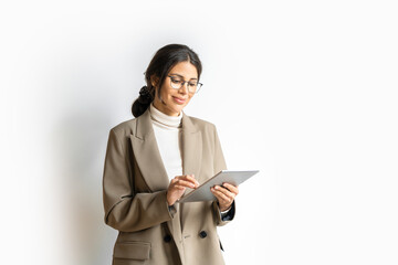 Smiling young middle eastern Israel businesswoman using tablet pc online application for work...