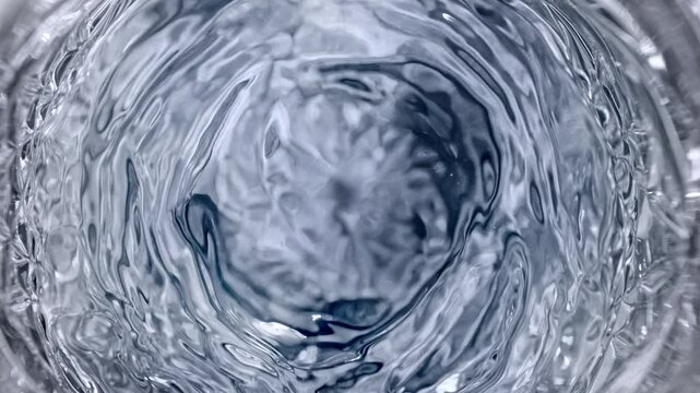 Super Slow Motion Detail Shot of Waving Vodka in Glass at 1000 fps.