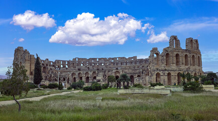 Amphitheater of El Jem in Tunisia with blue sky and clouds..
