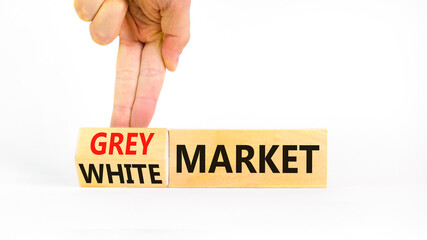 Grey or white market symbol. Concept words Grey market or White market on beautiful wooden blocks. Beautiful white background. Businessman hand. Business grey or white market concept. Copy space.