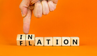 Flation or inflation symbol. Concept words Inflation or Flation on beautiful wooden blocks. Beautiful orange table orange background. Businessman hand. Business flation inflation concept. Copy space