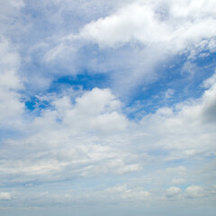 Blue sky with light, cumulus clouds.