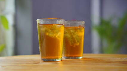 Two glasses of Ocha tea are served on the restaurant table and ready to drink.