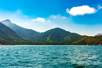 Arrive by boat at the famous Bonete beach on the island of Ilhabela surrounded by mountains and forests