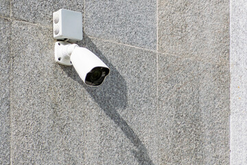 outdoor surveillance camera on concrete wall