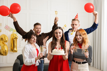 21st birthday. Group of happy friends with tasty cake having coming of age party at home