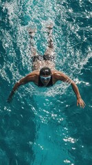 Dynamic Swimmer in Motion Captured in a Vibrant Clear Pool