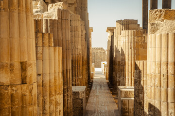 Yellow ancient stone columns in the pyramid complex in Egypt