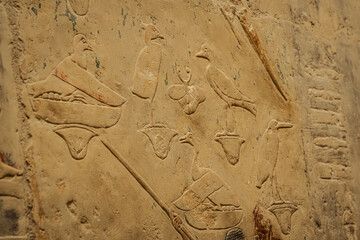 Egyptian hieroglyphs and paintings on the walls of Egyptian ancient temples