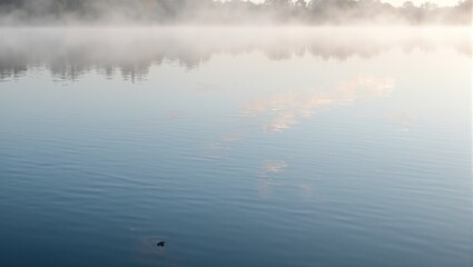 Fototapeta premium Tranquil freshwater lake at dawn with misty layers and pastel sky reflections