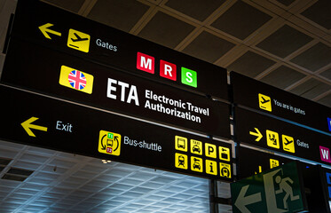 Information panel with Electronic Travel Authorization on it at an international airport. Digital...
