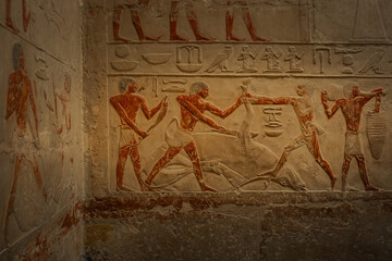 Obraz premium Egyptian hieroglyphs and paintings on the walls of Egyptian ancient temples