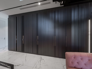 Wooden black cabinet in a private house