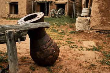 Antique jug against the background of an old town street. Sarai-Batu, Russia, Astrakhan region.