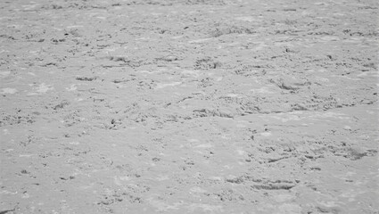 Fototapeta premium Close up of wet concrete with smooth ridges ripples and aggregate peeking through