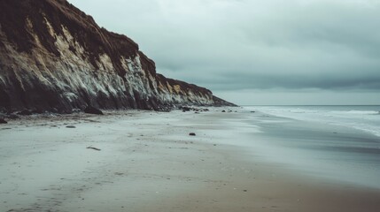Fototapeta premium A serene coastal view showcasing dramatic cliffs and gentle waves. The soft beach reflects tranquility while the clouds promise a story. Generative AI