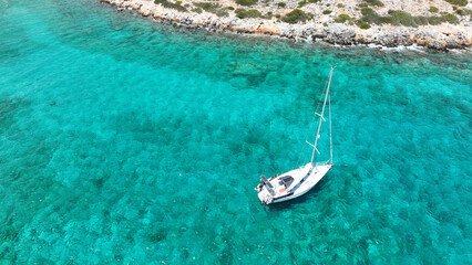 Obraz premium Aerial drone photo of paradise two sided beach with crystal clear emerald sea in small islet of Kounoupa near Astypalaia island, Dodecanese, Greece