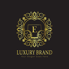 Letter Luxury brand logo design with a royal gold crown emblem and elegant typography
