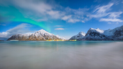 Aurora Borealis in Norway, Lofoten islands. Northern lights over the mountains. Starry sky. Winter landscape on the north. Photo for background, wallpaper, postcards.