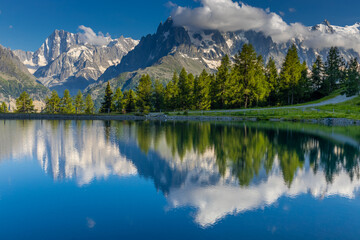 Fototapeta premium Lake in the Alps. Beautiful clear turquoise water lake in Chamonix Mont Blanc valley in French Alps. Alpine beautiful scenery in summer with blue sky