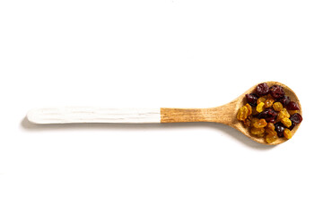 Dried fruits wooden spoon on white background with copy space. Symbols of Jewish holiday Tu Bishvat. Healthy snack - mix of organic dried fruits.
