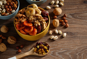 Dried fruits wooden spoon on white background with copy space. Symbols of Jewish holiday Tu Bishvat. Healthy snack - mix of organic dried fruits.