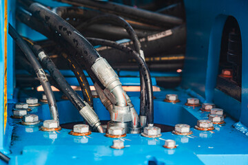 High pressure hydraulic hose system connected to steel pipes, close-up. Marine hydraulics.