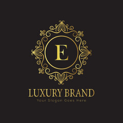 Letter Luxury brand logo design with a royal gold crown emblem and elegant typography

