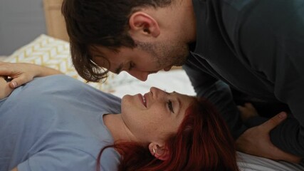 Couple embracing lovingly on bed in cozy bedroom showcasing intimate relationship and home comfort.