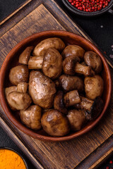 Grilled champignon mushrooms with salt, spices and herbs