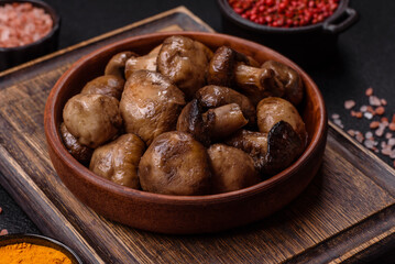 Grilled champignon mushrooms with salt, spices and herbs