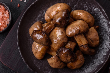 Grilled champignon mushrooms with salt, spices and herbs