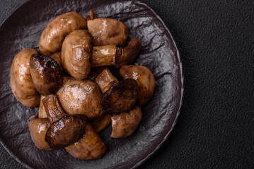 Grilled champignon mushrooms with salt, spices and herbs