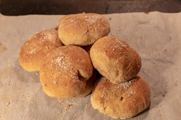 Graham flour bread buns newly baked on oven plate
