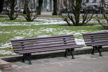 Empty park chairs in cold winter time for very lonely moments with no one around