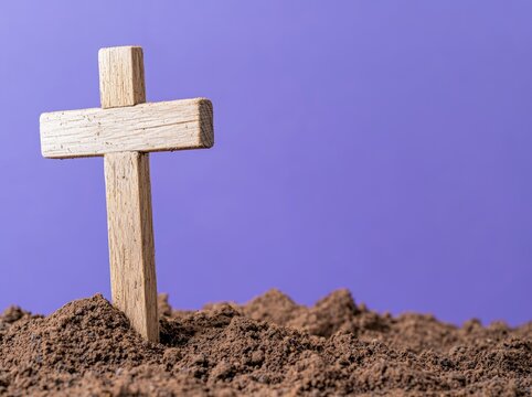 Lent Season, Holy Week, and Good Friday concepts - a wooden cross with ash on a blurred vintage purple background