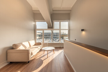 Modern Minimalist Loft Home Living Room Interior with Natural Light Streaming Through Large Windows
