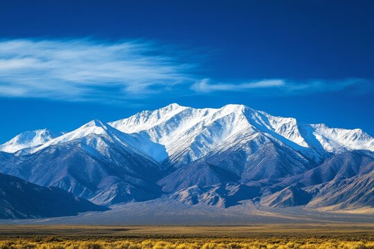 Snow-capped mountains under a clear blue sky
