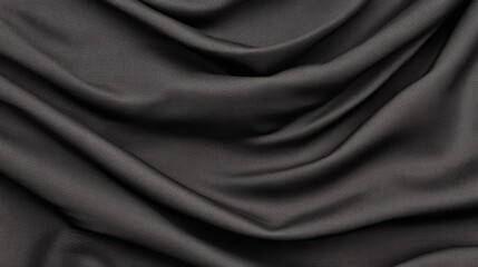 Fototapeta premium Draped dark gray fabric texture background.