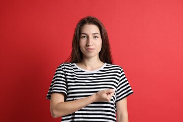 Fototapeta premium Woman making promise on red background. Oath gesture