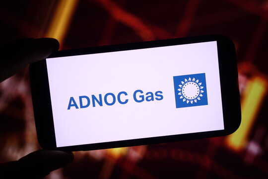 Konskie, Poland - December 01, 2024: ADNOC Gas company logo displayed on mobile phone