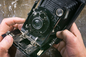 A young man studies old motor vehicles. Close-up of hands.
