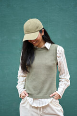 Happy cool fashion model beautiful generation z hipster teenage Asian girl wearing khaki cap and...